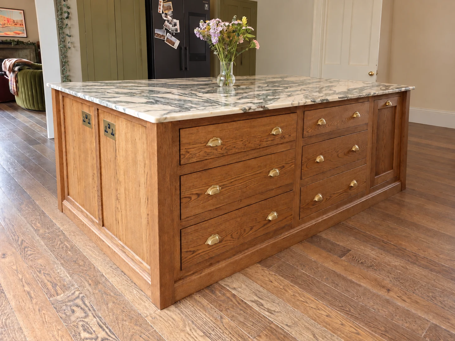 Bespoke oak kitchen island with deep drawers, brass handles and a marble worktop