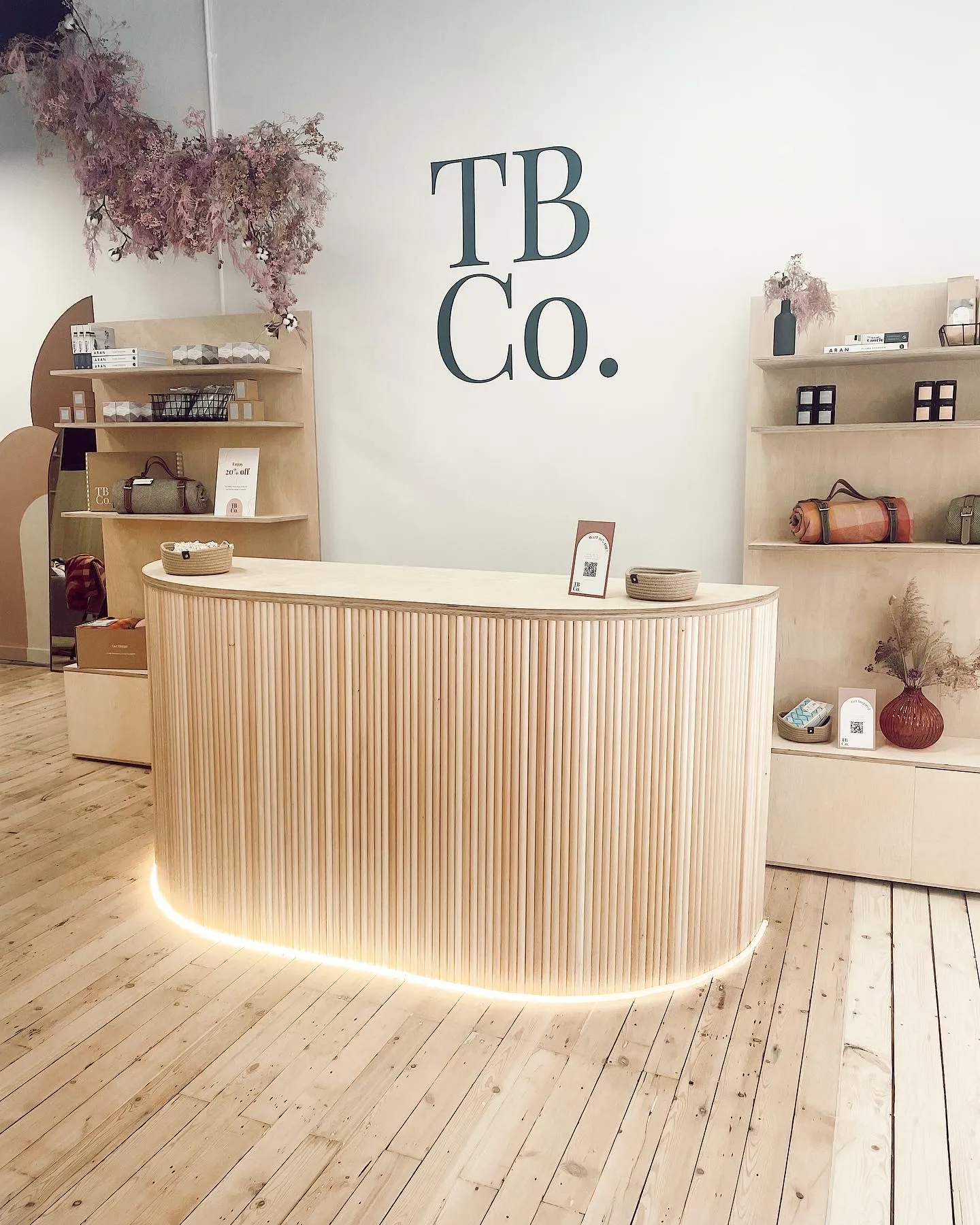 Curved timber retail counter with vertical slatted detailing